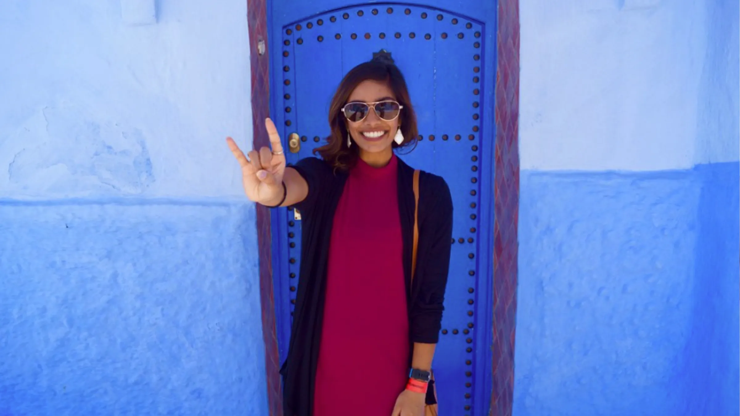 student in front of blue door in Morocco